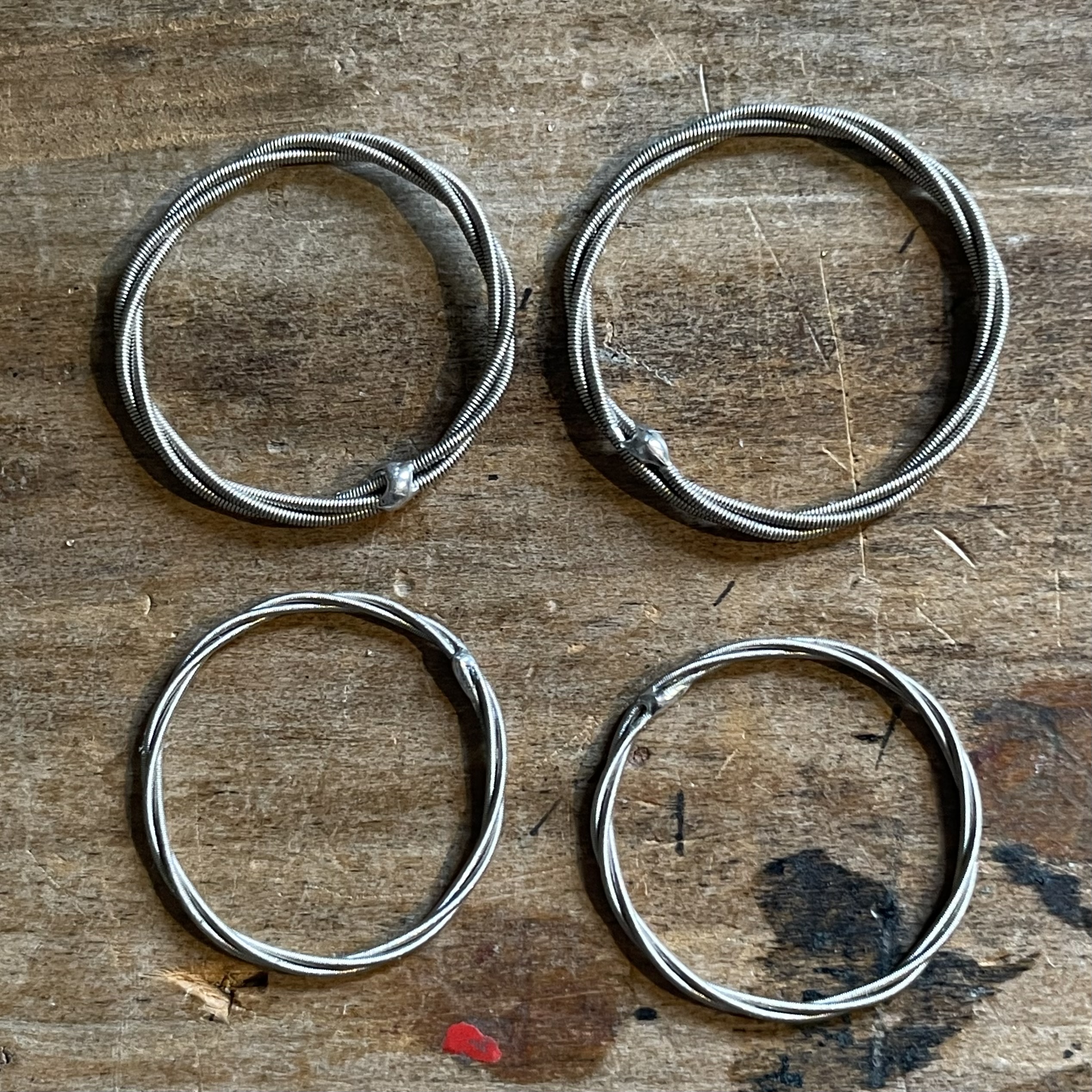 4 rings i made from a relative's old banjo strings