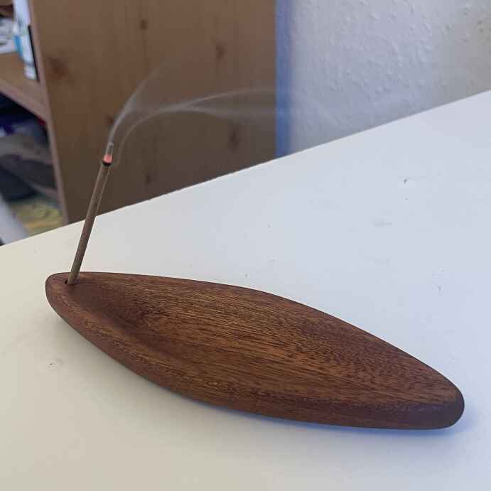 a boat shaped incense holder in mahogany
